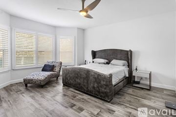 Winter Garden house for rent - A modern living room with a grey sofa and a stone fireplace.