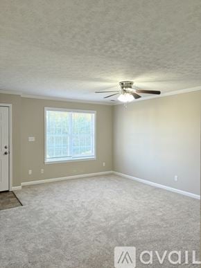 Bowling Green townhouse for rent - A room with a carpeted floor, a ceiling fan, and a window.