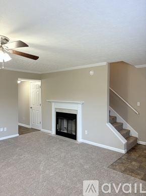 Bowling Green townhouse for rent - A living room with a fireplace and stairs leading to the second floor.