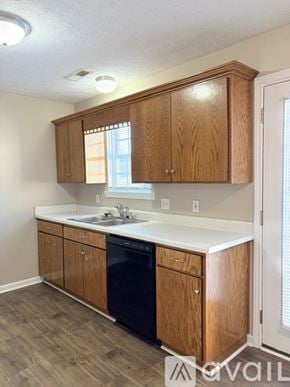 Bowling Green townhouse for rent - A kitchen with wooden cabinets and a black dishwasher.
