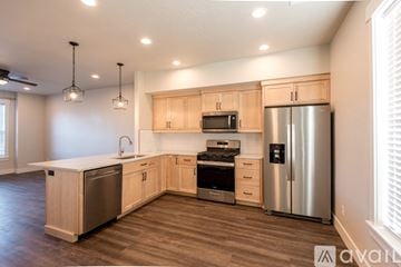Fruitland apartment for rent - A kitchen with wooden cabinets and stainless steel appliances.