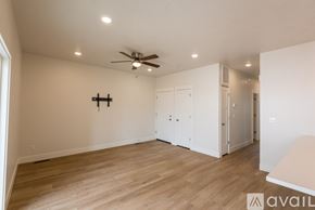 Payette apartment for rent - A spacious room with a ceiling fan and lighting fixtures.