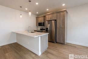 Payette apartment for rent - A kitchen with a white countertop and wooden cabinets.