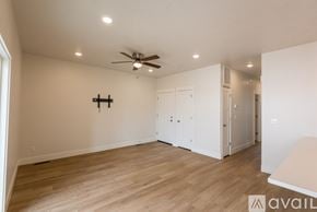 Payette apartment for rent - A spacious room with a ceiling fan and lighting fixtures.