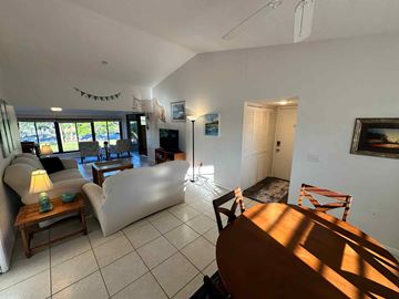 Bradenton house for rent - A living room with a white couch, a wooden table, and a painting on the wall.