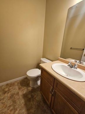 London house for rent - A bathroom with a toilet, sink, and mirror.