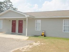 Raeford apartment for rent - A house with a red door and a small porch.