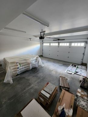 Victoria apartment for rent - A room with boxes and a ceiling fan.