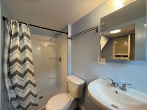 Sitka apartment for rent - A bathroom with a toilet, sink, and shower.