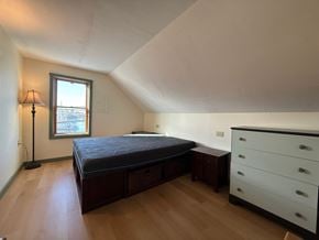 Sitka apartment for rent - A bedroom with a bed, dresser, and window.