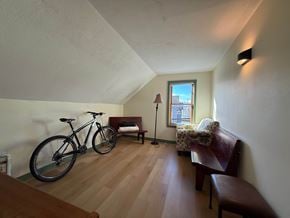 Sitka apartment for rent - A room with a bicycle, a bench, and a lamp.
