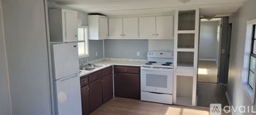 Dublin apartment for rent - A kitchen with white appliances and brown cabinets.
