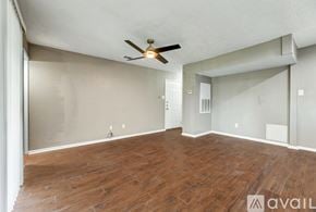 Bryan apartment for rent - A room with wooden flooring and a ceiling fan.