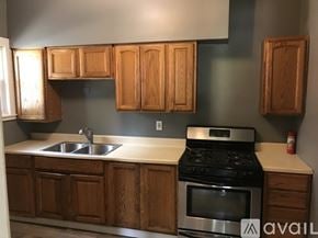 Warren house for rent - A kitchen with wooden cabinets and a stove top oven.