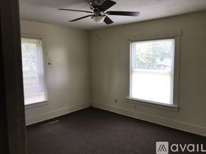 Warren house for rent - A room with a ceiling fan and two windows.