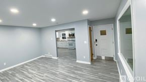 Milwaukee house for rent - A spacious room with grey flooring and white walls.