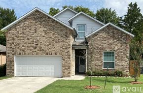 Dallas house for rent - A two-story house with a garage door and a driveway.