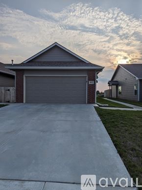 Wichita townhouse for rent - A house with a garage door in front of it.