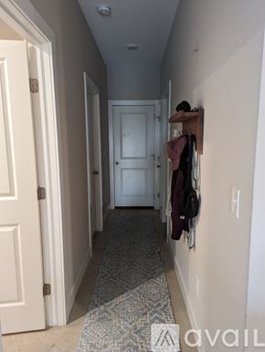 Wichita townhouse for rent - A hallway with a rug on the floor and a coat rack on the wall.