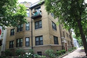 Chicago apartment for rent - A building with a balcony and trees in front.