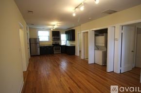 Chicago apartment for rent - A kitchen with wooden floors and white appliances.