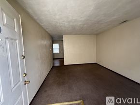 Springfield apartment for rent - A room with a white door and carpeted floor.