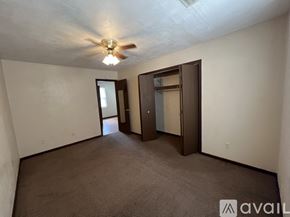 Springfield apartment for rent - A room with a ceiling fan and two doors.