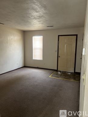 Springfield apartment for rent - A room with a carpeted floor, a door, and a window with blinds.