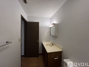 Springfield apartment for rent - A bathroom with a sink, mirror, and toilet.
