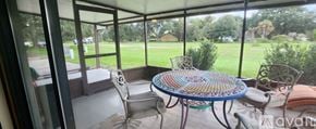 Dade City house for rent - A patio with a round table and chairs is shown.