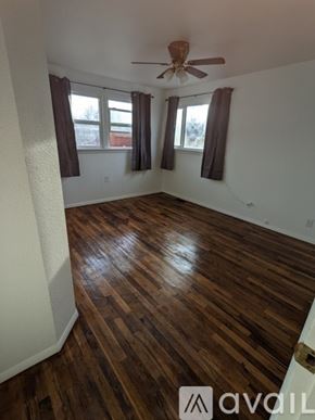 Grand Junction townhouse for rent - A room with wooden flooring and a ceiling fan.