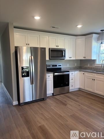 Mount Airy house for rent - A kitchen with a stainless steel refrigerator and microwave.