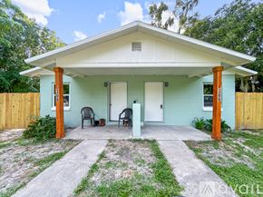 Ocala house for rent - A small house with a porch and two chairs.