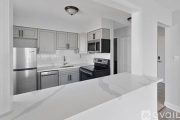 Chicago apartment for rent - A kitchen with a white counter top and stainless steel appliances.
