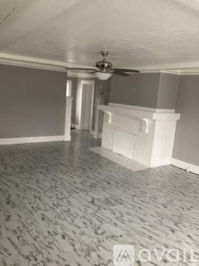 Peoria apartment for rent - A room with a ceiling fan and a fireplace.