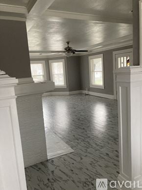 Peoria apartment for rent - A room with a ceiling fan and marble flooring.