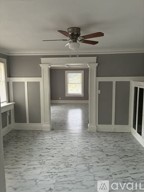 Peoria apartment for rent - A room with a fan and marble flooring.
