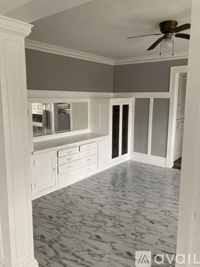 Peoria apartment for rent - A room with a ceiling fan and a marble floor.
