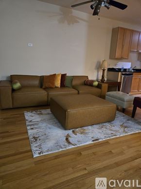 Chicago townhouse for rent - A living room with a brown couch and a rug.