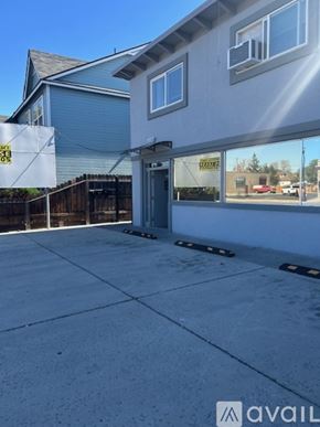 Sparks apartment for rent - A large, empty parking lot in front of a building with a sign that reads "AVAIL".