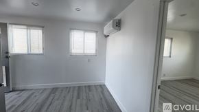 Sparks apartment for rent - A room with wooden flooring and two doors.