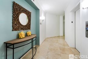 Miami Beach apartment for rent - An aerial view of a swimming pool surrounded by lounge chairs and palm trees.