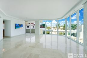 Miami Beach apartment for rent - A playground with a slide and a wooden bench in front of a tall building.