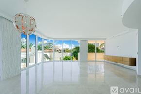Miami Beach apartment for rent - A small putting green is surrounded by palm trees and other greenery.