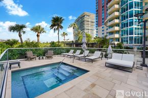 Miami Beach apartment for rent - A kitchen with a white countertop and wicker chairs.