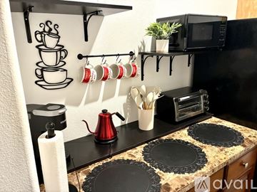 Indio house for rent - A kitchen with a black countertop and a coffee maker.