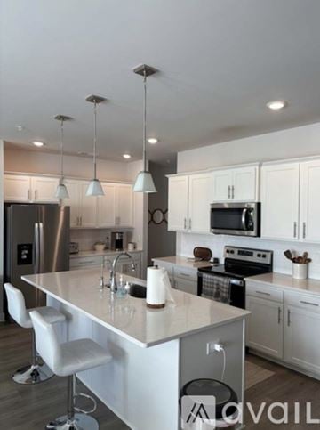 Spring Hill townhouse for rent - A modern kitchen with a central island and pendant lights.