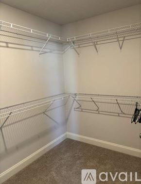 Spring Hill townhouse for rent - A room with white walls and a carpeted floor with a metal rack on the wall.