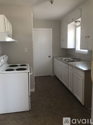 Corpus Christi apartment for rent - A kitchen with white appliances and cabinets.