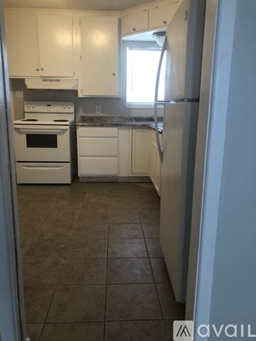 Corpus Christi apartment for rent - A kitchen with white appliances and cabinets.
